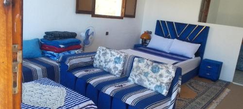 a room with a bed and two couches in it at panorama view in Chefchaouen