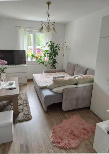 a bedroom with a large bed and a couch at Dana in Sokołowsko