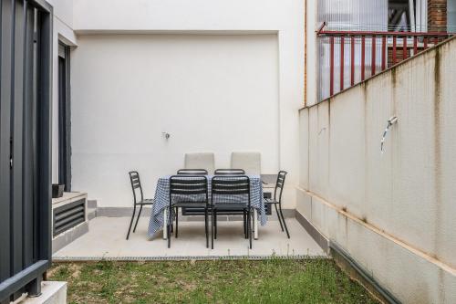 a table and chairs sitting on a patio at Spacious Home with Private Garden and Parking in Madrid