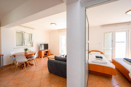 a bedroom with a bed and a living room at Grand Holiday Residence in Komarna