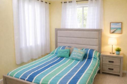 a bedroom with a bed with two pillows on it at crown y key in Ciales