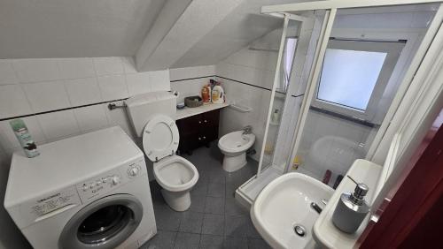 a small bathroom with a toilet and a sink at Ampia casa marinara con meravigliosa terrazza vista mare Da Mario e Rosanna in Portovenere