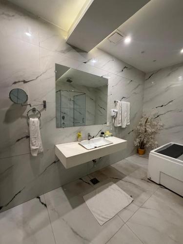 a bathroom with a sink and a mirror at Hilton Suites Lahore in Lahore