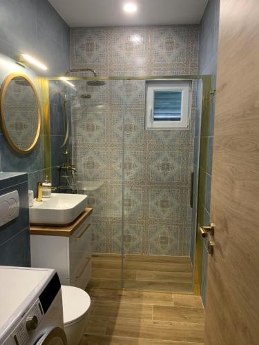 a bathroom with a shower and a toilet and a sink at Holiday Home Laurea in Supetar