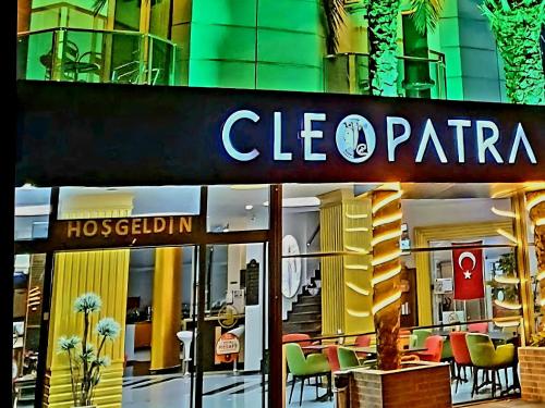 a store with a sign on the front of a building at Cleopatra City Hotel Alanya in Alanya