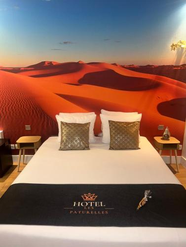 a bedroom with a bed in the desert at Hôtel les Paturelles in Avesnelles