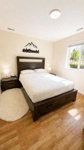 a bedroom with a large bed and a rug at Bright & Cozy Private 1BR Suite in Whitehorse