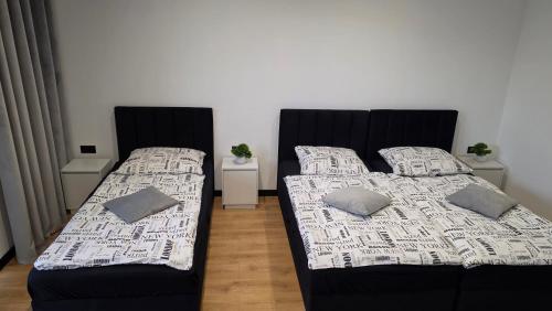 zwei Betten, die in einem Zimmer nebeneinander stehen in der Unterkunft ANPOL komfort in Inowrocław