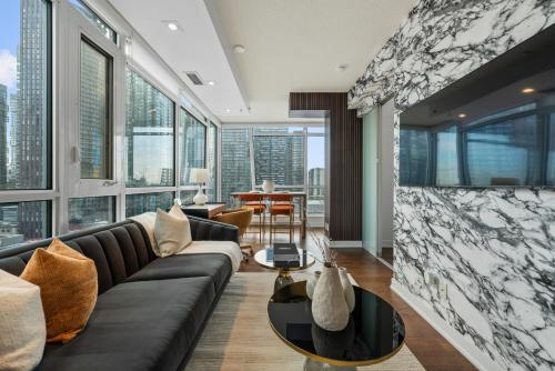 a living room with a couch and a table at NoMad Suites - Toronto's Entertainment District in Toronto