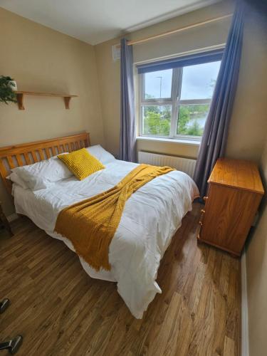 a bedroom with a large bed with a window at The Yellow Bollard in Galway
