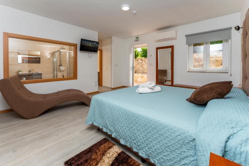 a bedroom with a bed and a large mirror at Quinta de Real in Valença