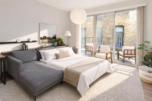 a bedroom with a bed and a couch and a living room at Charming Walker's Point Apt with Balcony | Sleeps 4 in Milwaukee