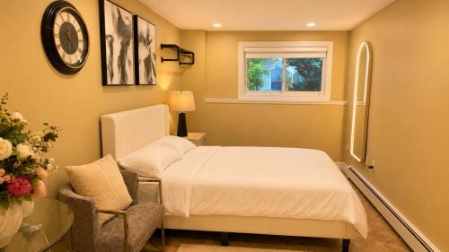 a bedroom with a bed and a chair and a window at Private Two Queen Beds Room Near UPEI & Downtown Cozy Retreat Near Everything in Charlottetown