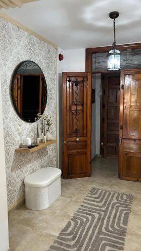 a living room with a mirror and a door at Balcón de Mágina in Torres
