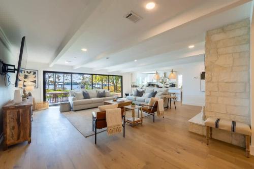 a large living room with a couch and a fireplace at Waterfront Paradise Dock Pool Boathouse in Jacksonville