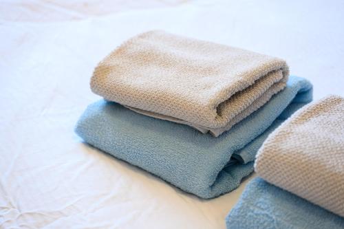 a pile of towels sitting on top of a bed at Royal Sea Panorama in Komarna