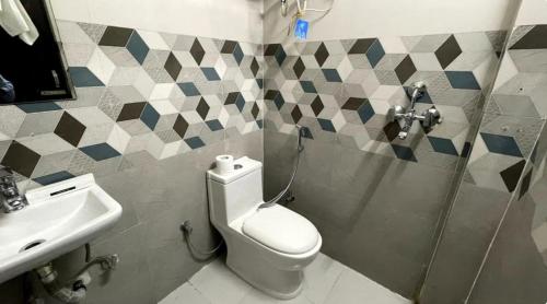 a bathroom with a toilet and a sink at The Langford in Bhaktapur