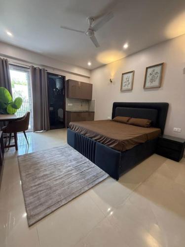 a bedroom with a bed and a living room at The Langford in Bhaktapur