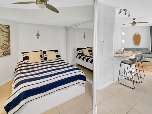 a bedroom with a bed and a desk in a room at Mooloolaba Magic at Beachclub Mooloolaba in Mooloolaba