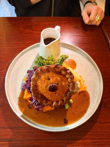 a plate of food on a table with a cup of coffee at The Old Manor House Hotel in Keynsham