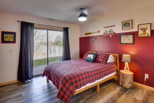 a bedroom with a bed with a red wall at 3-Unit Combo w/ Dock on Lake Keowee - Hike & Fish! in Seneca