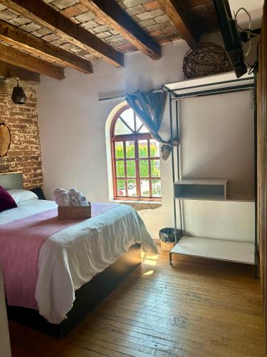 a bedroom with a large bed and a window at Hotel Portal & Suites in Ciudad Hidalgo