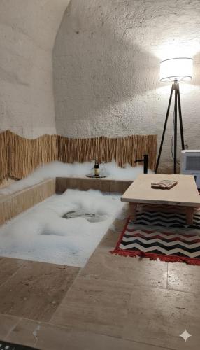 a living room with a table and snow on the floor at Route Cappadocia in Avanos