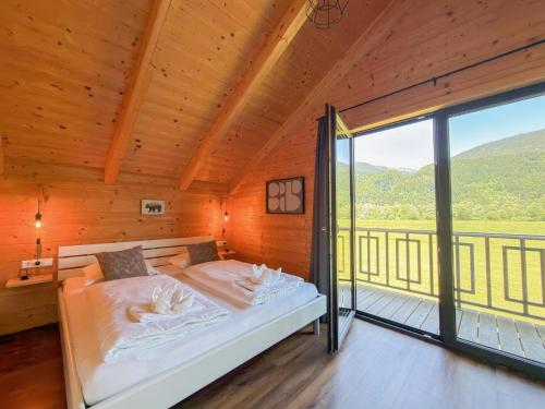 a bedroom with a bed and a large window at Rattendorf 13B in Rattendorf