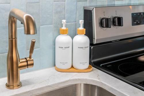 two bottles sitting on a counter next to a sink at Penthouse Oceanfront Studio VR + Mural + Minibar in Myrtle Beach