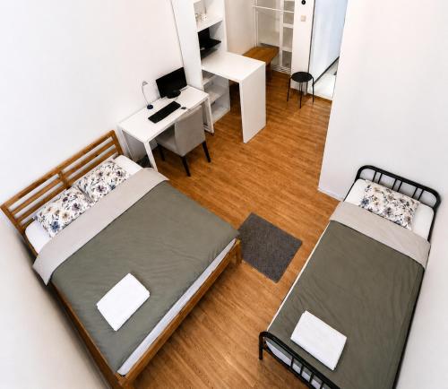 an overhead view of a bedroom with two beds and a desk at StaySpace in Graz
