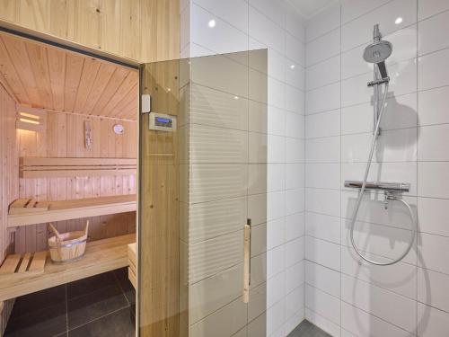 a shower with a glass door in a bathroom at Sea Quality 83 in Colijnsplaat