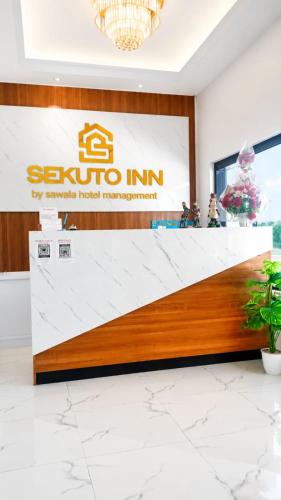 a lobby of a hotel with a reception counter at Sekuto Inn by Sawala in Tegal