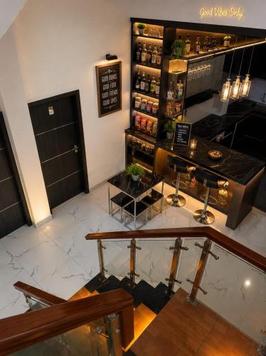 a bar in a restaurant with a counter and benches at Sekuto Inn by Sawala in Tegal