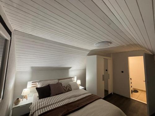 a bedroom with a bed with a wooden ceiling at Kuća za odmor Štiba in Vinkovci