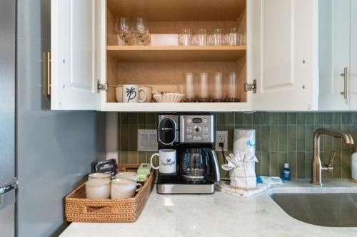 a kitchen counter with a coffee maker and a microwave at Penthouse 1BR + Bunk Room Boardwalk View Zone in Myrtle Beach