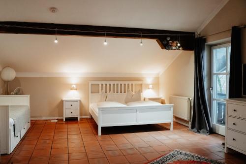 a bedroom with a white bed and a window at Fischerstüberl Attel in Wasserburg am Inn