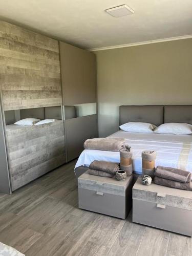 a bedroom with two beds and a large mirror at Hamallaj Bliss in Draç