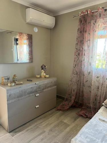 a bathroom with a sink and a mirror and a window at Hamallaj Bliss in Draç