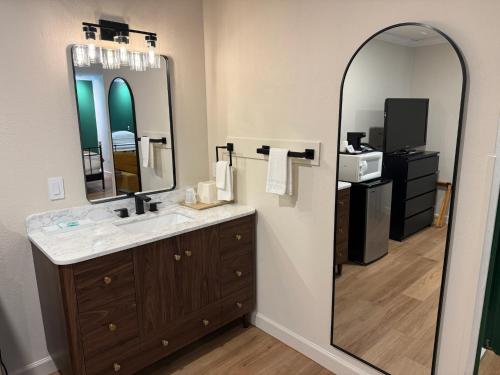 a bathroom with a sink and a large mirror at Boulder Twin Lakes Inn in Boulder