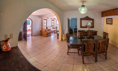 a living room with a table and a dining room at Hotel Casa Grande in Taxco de Alarcón