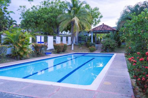 a swimming pool in front of a house at Le”More House in Girardot
