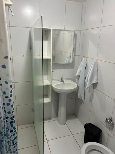 a white bathroom with a sink and a mirror at PÉ NA AREIA EM Pirangi do Norte in Parnamirim