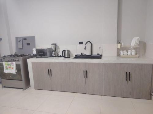 a kitchen with a sink and a counter top at Minidepartamento Independiente in San José de Chaltura