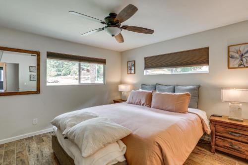 a bedroom with a large bed with a ceiling fan at Pool & Dual Decks! Modern Trinity River Retreat in Lewiston