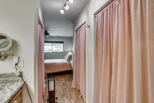 a bedroom with pink curtains and a bed at Pool & Dual Decks! Modern Trinity River Retreat in Lewiston