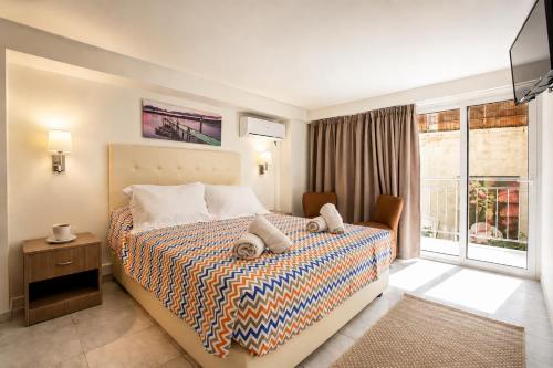 a hotel room with a bed and a window at City Life Port Hotel in Heraklio