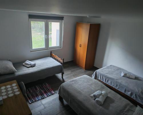 a room with two beds and a window at Dudov Hlad in Batina