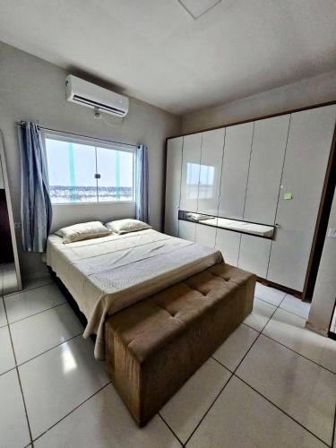 a bedroom with a large bed and a large window at Casa em Piranhas com piscina in Piranhas