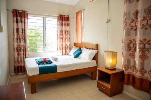 a bedroom with a bed with a gift on it at seaview apartment in Honiara