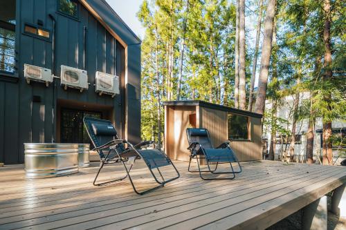 two blue chairs sitting on a wooden deck at Hakuba Bubu Chalet by Jade Villa in Hakuba